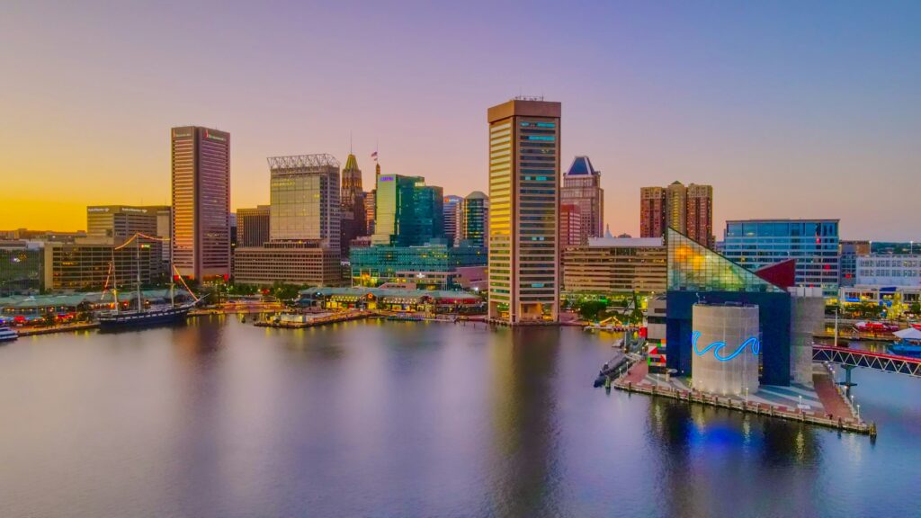 Baltimore logistics recruiters — Port of Baltimore cargo ships, freight trucks, warehouses, and skyline representing supply chain, e-commerce, and distribution recruiters