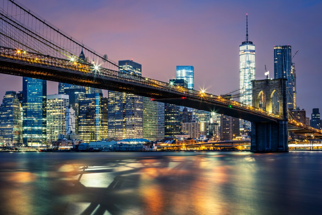 New York City supply chain recruiters — logistics warehouses, trucks, and Manhattan skyline representing top supply chain management and logistics recruiters